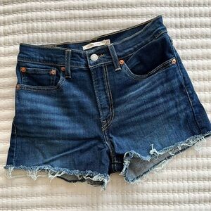 Levi’s | Dark blue wash high rise denim shorts. Size 27
